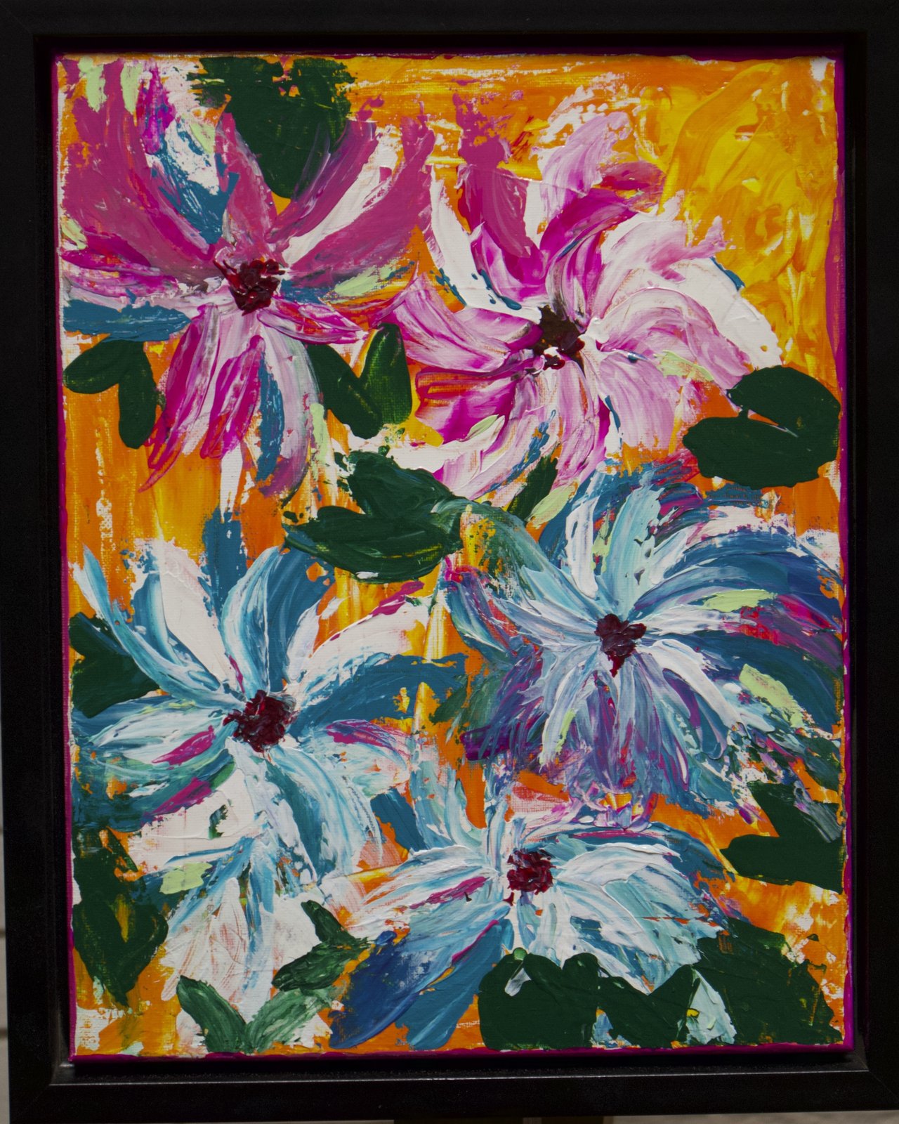 Vivid floral abstraction — pink, white, and blue palette-knife blooms over a bright orange ground, in a black floater frame.